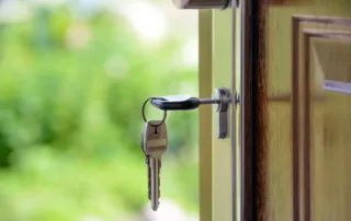 A key hanging out of a home’s front door.