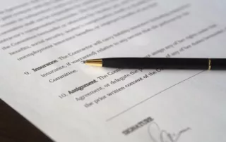 Up close contract with a pen lying across it.