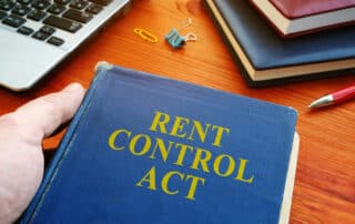 Man in holding Rent Control Act law.