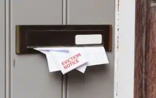 Eviction letter sticking out of a mailbox.
