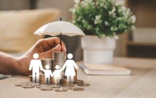 Wooden family figures with coins and umbrella, symbolizing insurance protection, financial security, savings planning, and life coverage for future stability.
