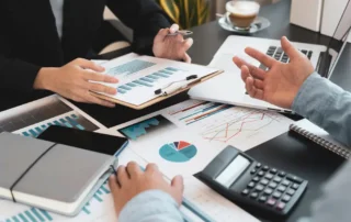 Business idea. Business people talking And calculations about charts and graphs showing the growth of investment results Of successful teamwork